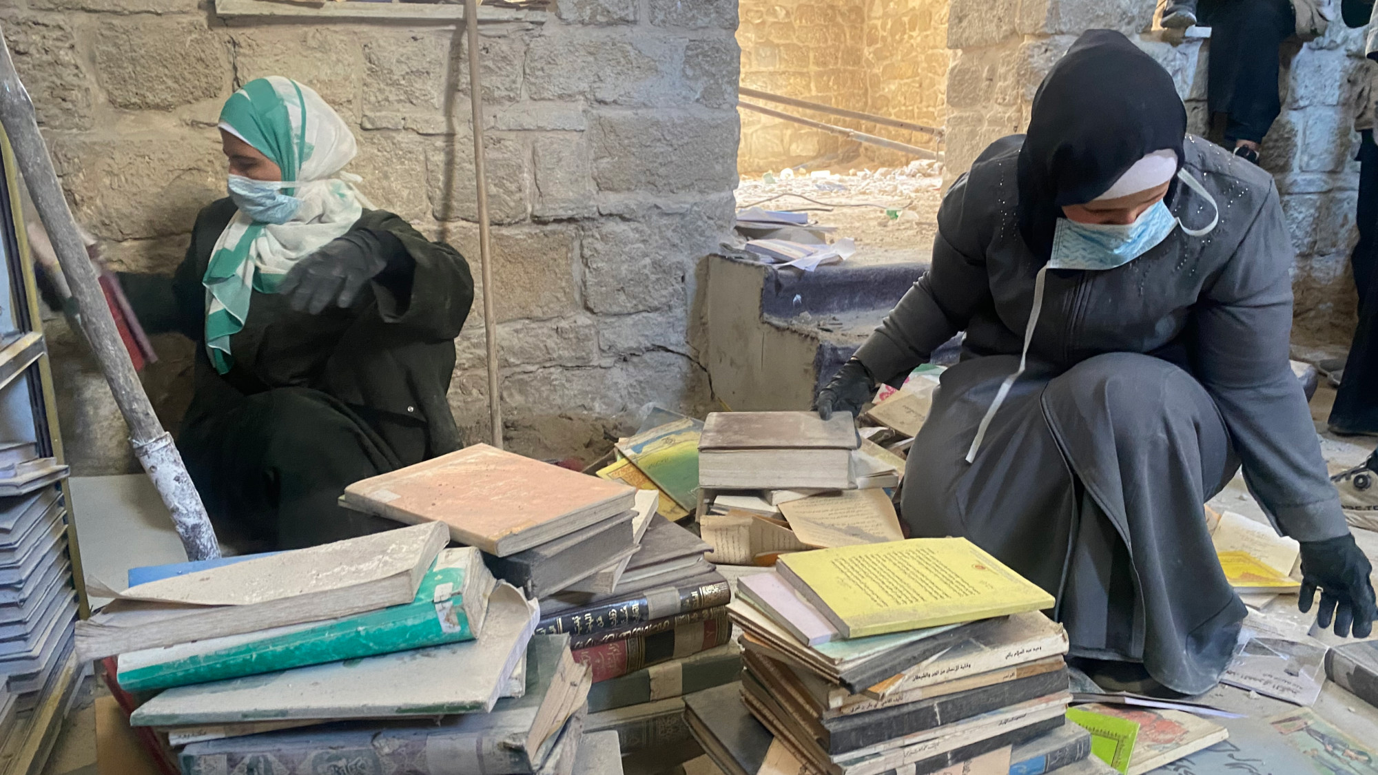 Under rubble and rain, Gaza women try to save rare books in a centuries-old library.