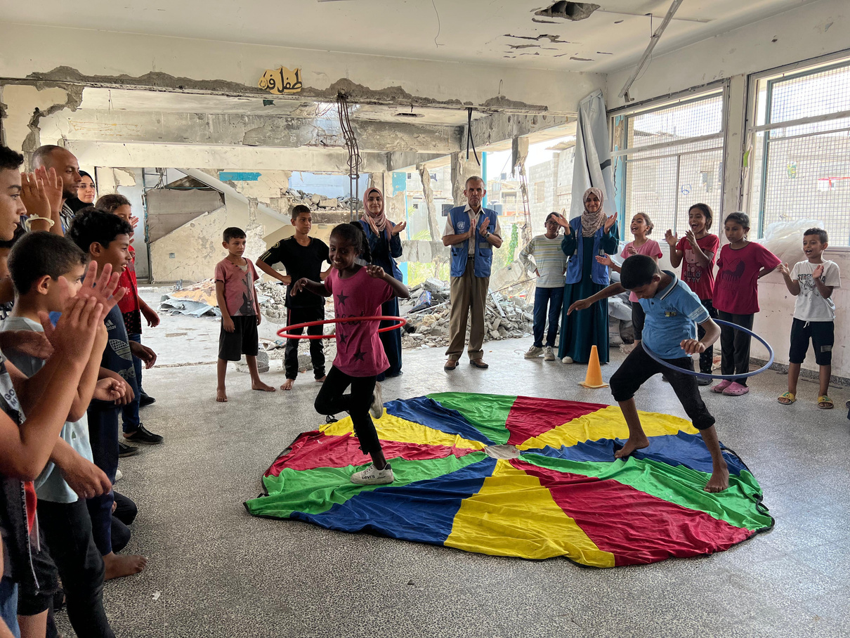 Children take part in activities organised by UNRWA teams in a damaged school.